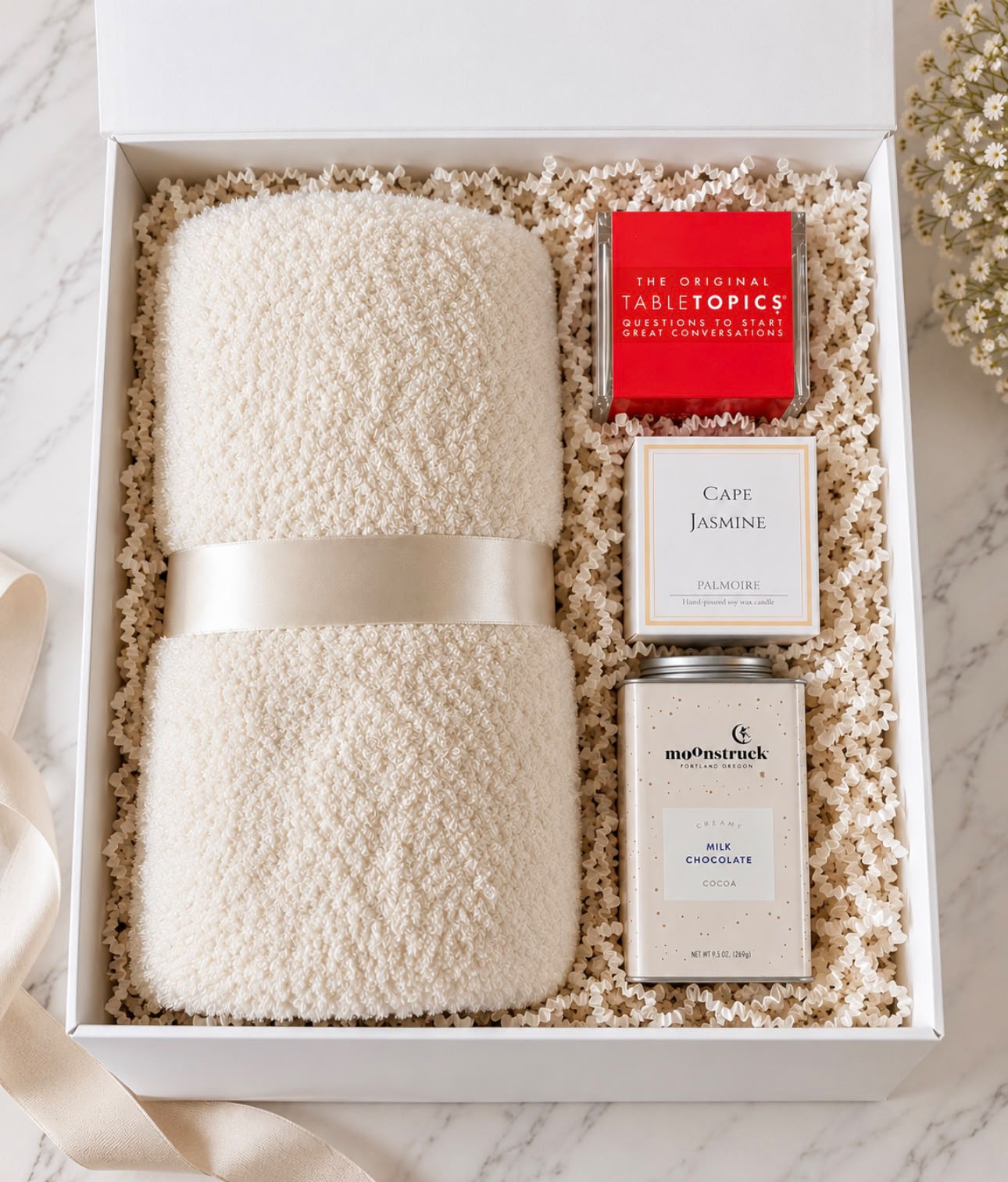 Fall into Cozy Nights gift box with a cozy blanket, candle, Table Topics and cocoa